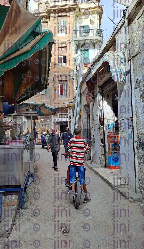 Kom El dekka street in Alexandria,Egypt and a kid driving a bicycle 