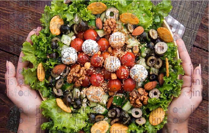 hands holding salad - stock image