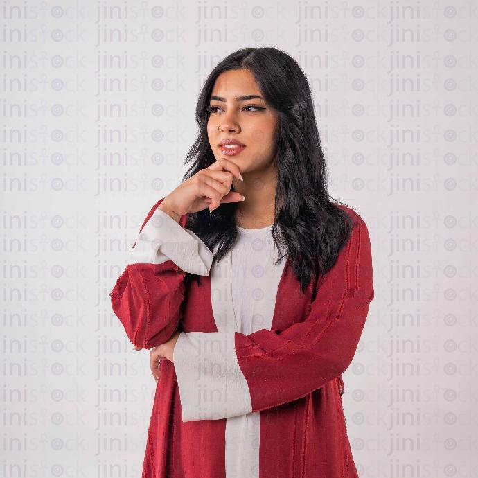 khaliji woman with red dress thinking stock image