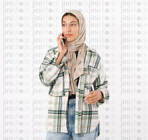 young hijabi girl looking surprised while talking on the phone