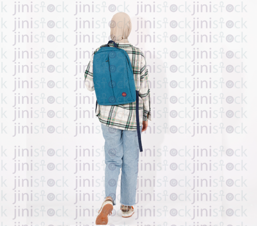 Full length back shot of a veiled female student in jeans with a backpack walking isolated on white background