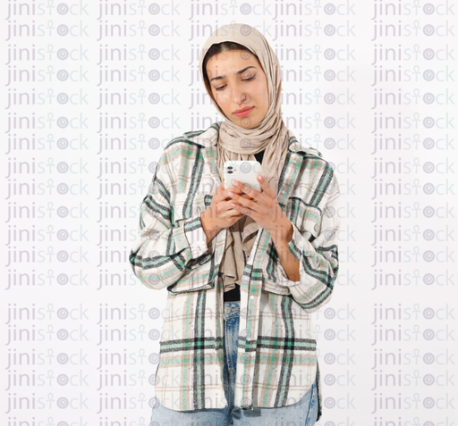Young happy casual hijabi with phone in hand looks dreamily to side distracted from shopping through mobile application and online