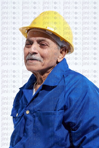 old happy worker in blue suite and yellow hat