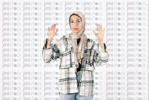 hijabi girl raising her hand in surrendering sign