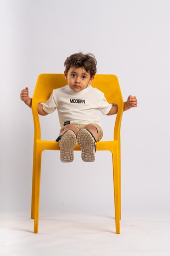 boy sitting on a chair - stock image