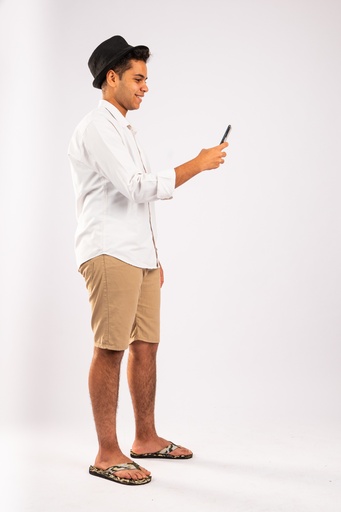 Egyptian man looking at his phone while walking - stock image