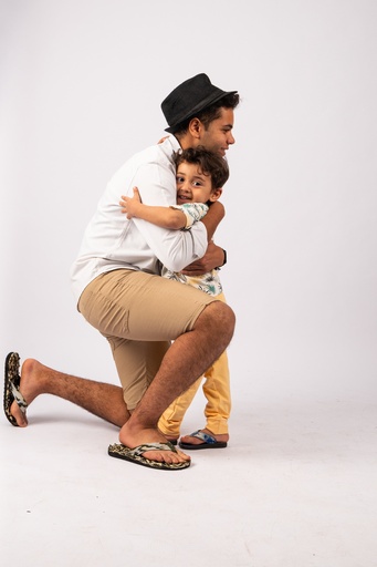 father hugging his son - stock image