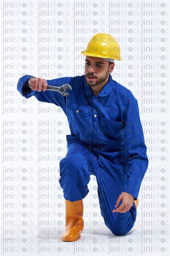 young worker on his knees working and fixing something