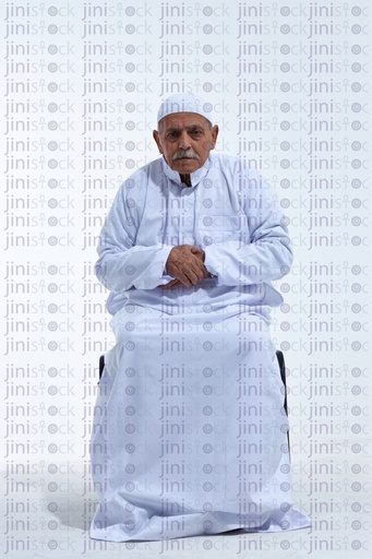 Old man sitting on a chair praying and folding his hands in front of him