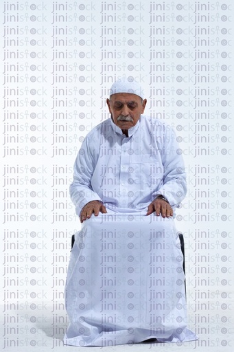 Old man on a white chair sitting sad