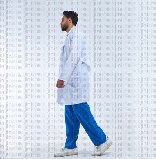 Doctor in a white coat walking side view