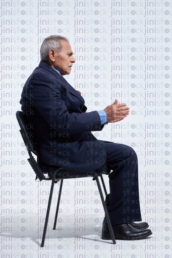 Old man in a business suite talking side view
