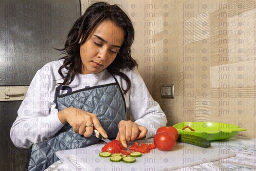 Egyptian woman cutting vegetables in the kitchen