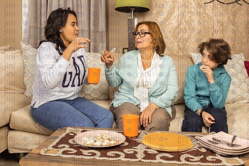 Egyptian family gathering on the couch in the living during eid festival