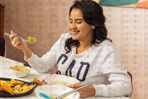 Egyptian woman eating happy on the dinning table