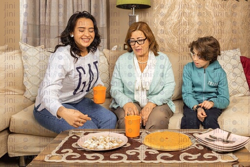 Family eating eid kahk ans sweets