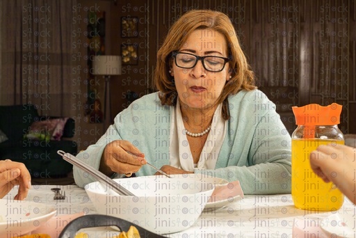 Grand mother eating at the family sofra table