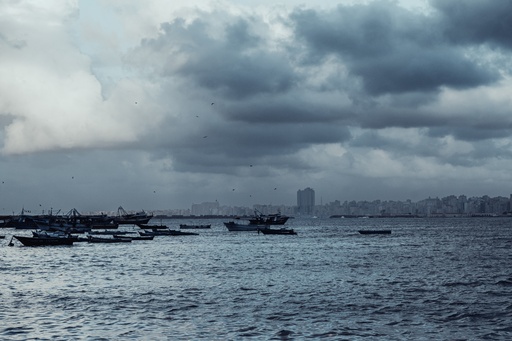 A number of small boats in the middle of the Abu Qir Beach sea - stock image