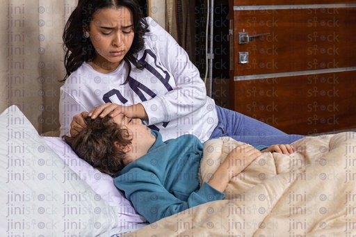 mother tending to her sick son