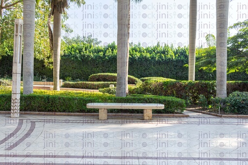 Bench in Azhar park in the middle of palm trees