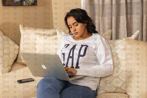 Woman working from home on the couch