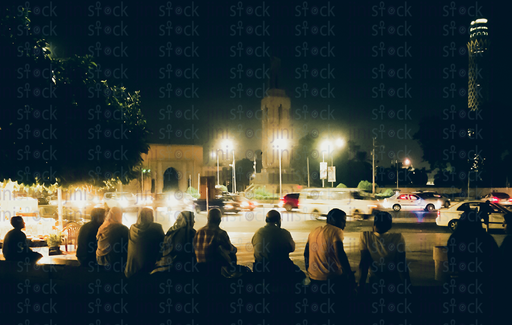 people sitting and watching the cars