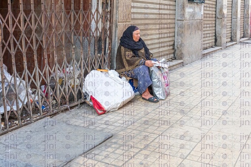 woman sitting on the side of the street