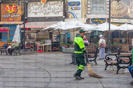 Street cleaner swiping garbage