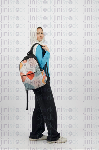 Girl holding study bag and looking to the side - side shot - stock image