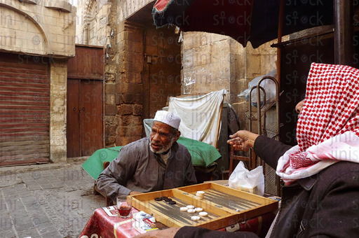 two old friends playing tawla in the old streets of Cairo