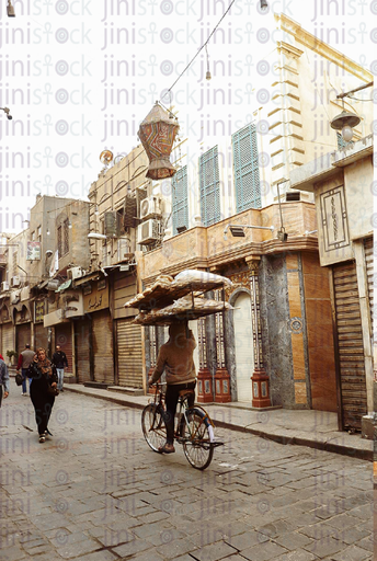 bread seller on a bicycle in old Cairo streets