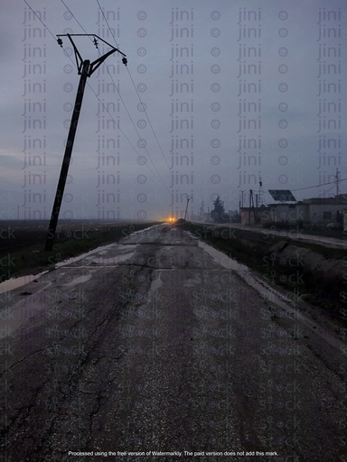 Muddy road or street in a village at night.