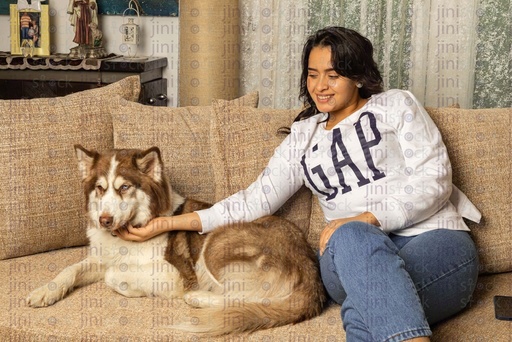 woman petting her dog on the couch