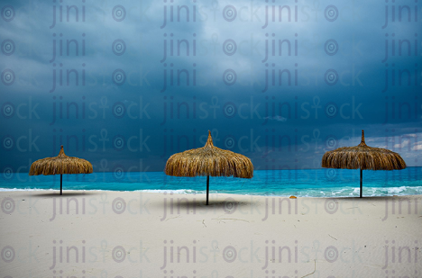 North Coast beach during the sunrise white sand and bohemian umbrella during the summertime