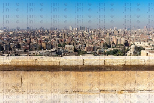 fence made of old rocks looking over cairo