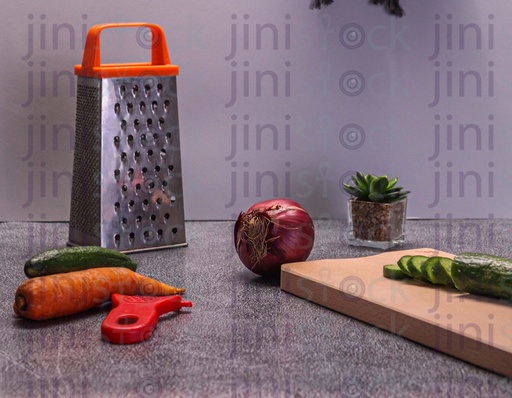 cutting board and shredder on a kitchen counter