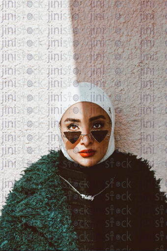 veiledwoman wearing fashionable sunglass - stock image