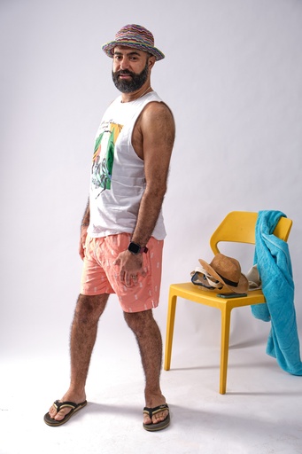 man looking at the camera in a summer outfit.