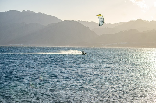 Kite surfing and the mountains in the background.