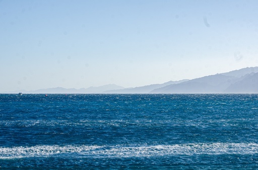 Dark sea in front of the mountains.