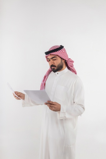 khaliji man reading paper stock image