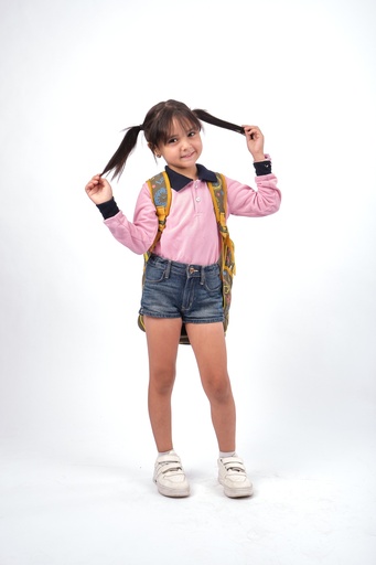 little girl in school uniform and playing with her hair