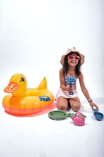 little girl playing on the beach in summer