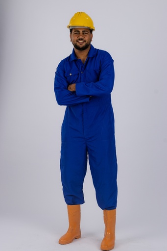 Worker or handy man in blue jumpsuit standing