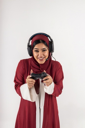 a girl from gulf playing playstation stock image with high quality on isolated image