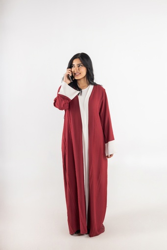 a stock image of a khaliji girl with long red dress talking on the mobile phone