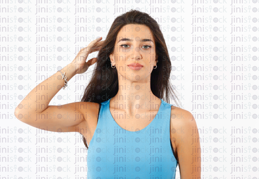 Isolated female model playing with her hair looking at the camera high quality stock image