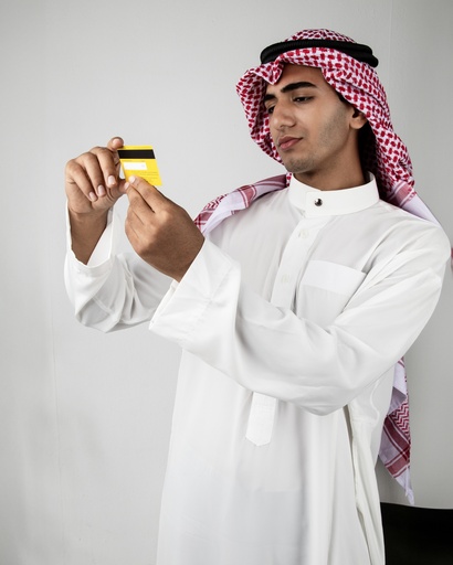 young man from the gulf holding credit card