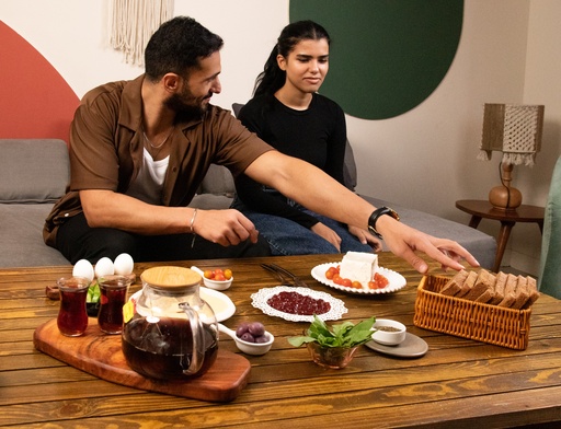  A young man and a young couple having breakfast