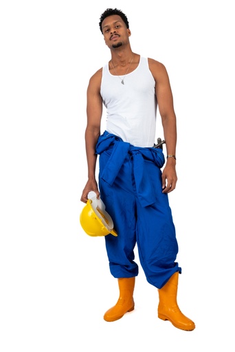 Egyptian worker in a blue uniform and holding a yellow hat in his hands